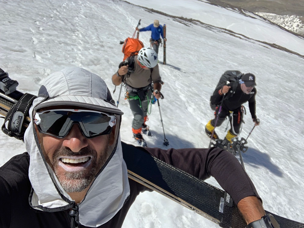 Teamwork 101. Myself and guide Eric (at the back also carrying skis) return from our first climb to Advance Camp One (5,700m) in order to lend a hand and relieve Gregory and Moss from the heavy loads they are hauling on their backs Photo credit: Maxime Chaya