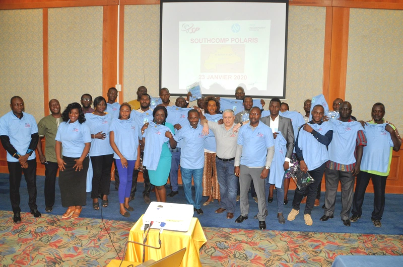 Group photograph of people trying on light blue t-shirts