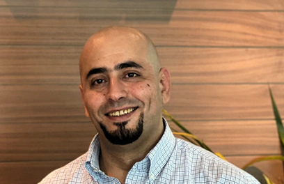 Head and shoulders photo of a man smiling at the camera