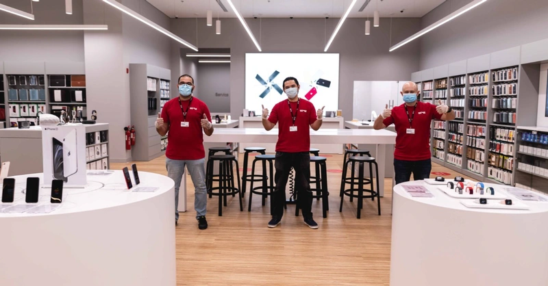 shows three people wearing masks in a hi tech shop 