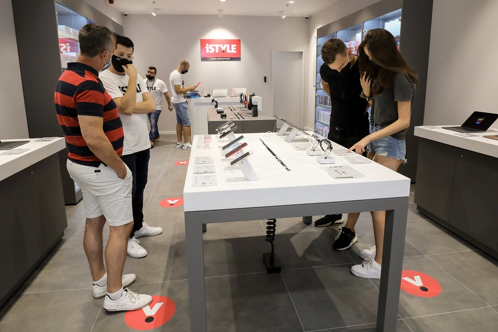 shows two people passing a purchase between them in a store