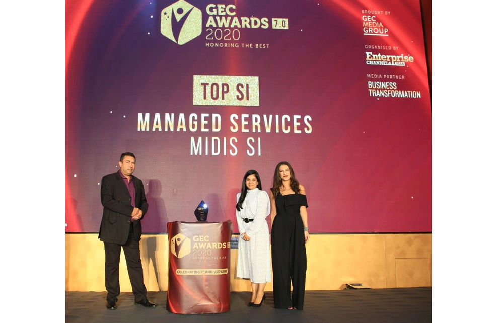 three people on stage at an award ceremony