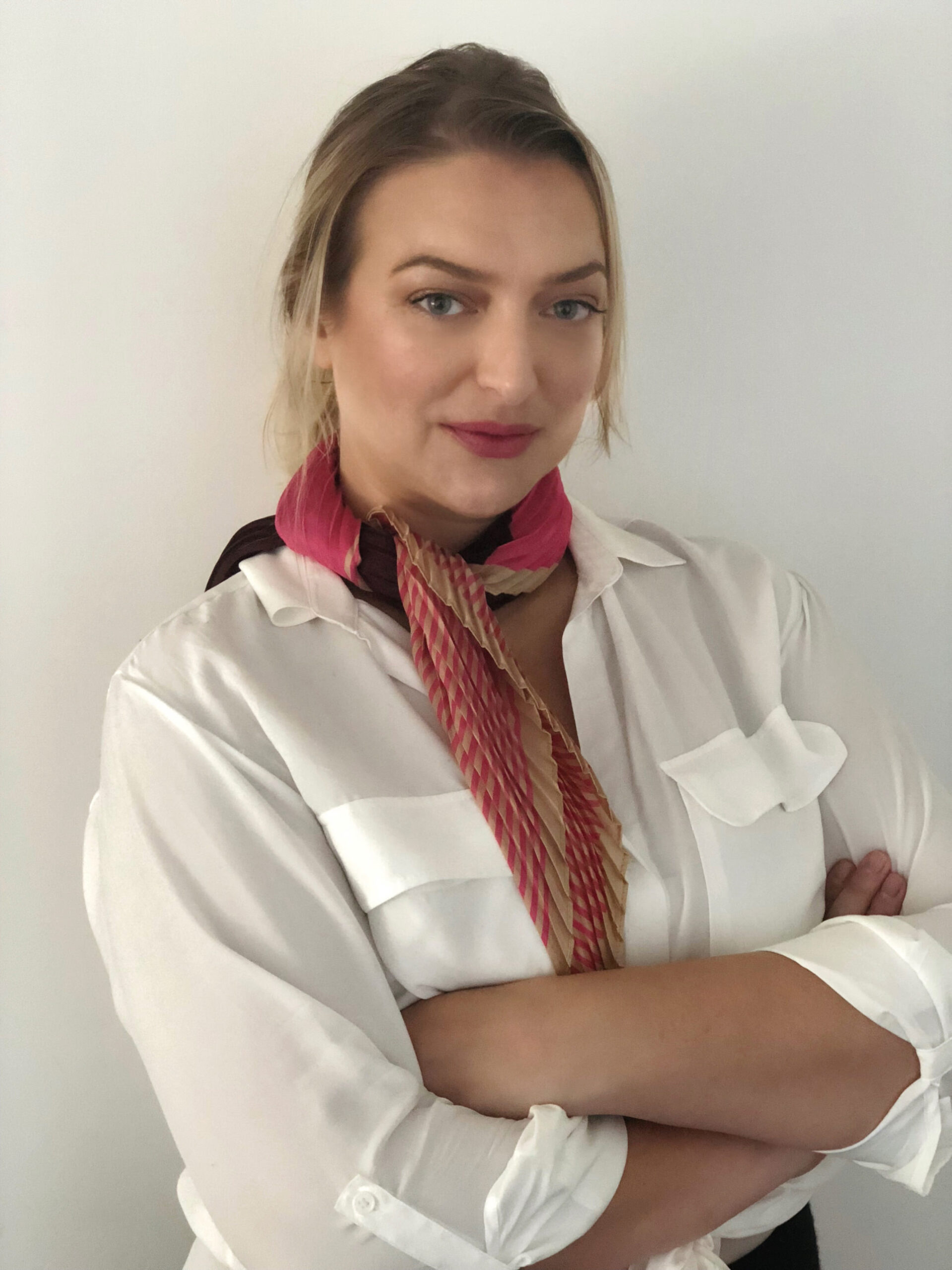 head and shoulders photo of a woman with folded arms