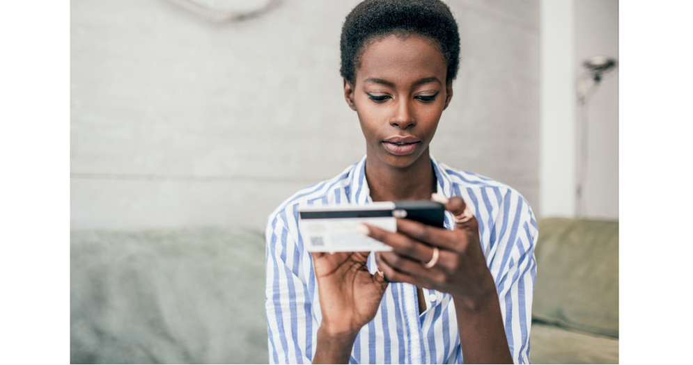 a woman is using a mobile phone to interact with her bank