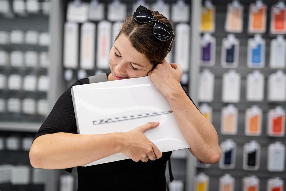 a woman is seen hugging a laptop to her chest