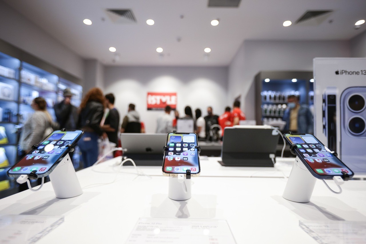 a hi tech store interior with Apple devices in the foreground