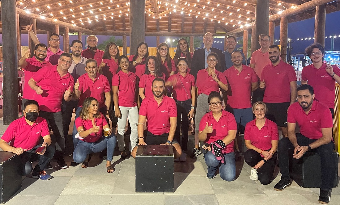 group of people all wearing pink t shirts