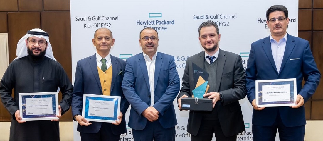 five men holding award certificates and a trophy