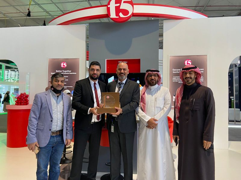 a group of people seen in front of an exhibition stand