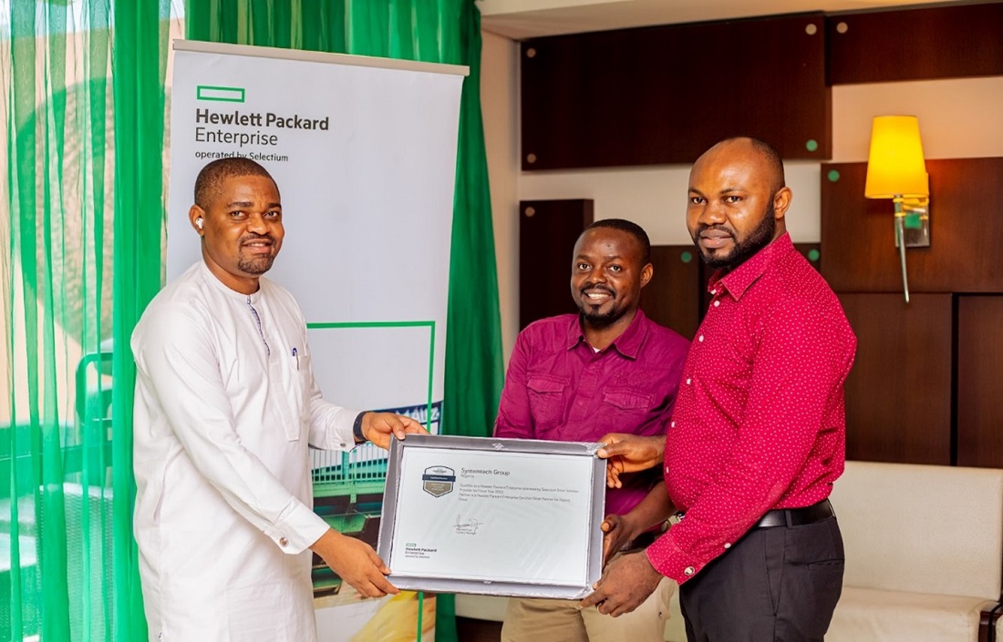 A man presents a certificate to two other men