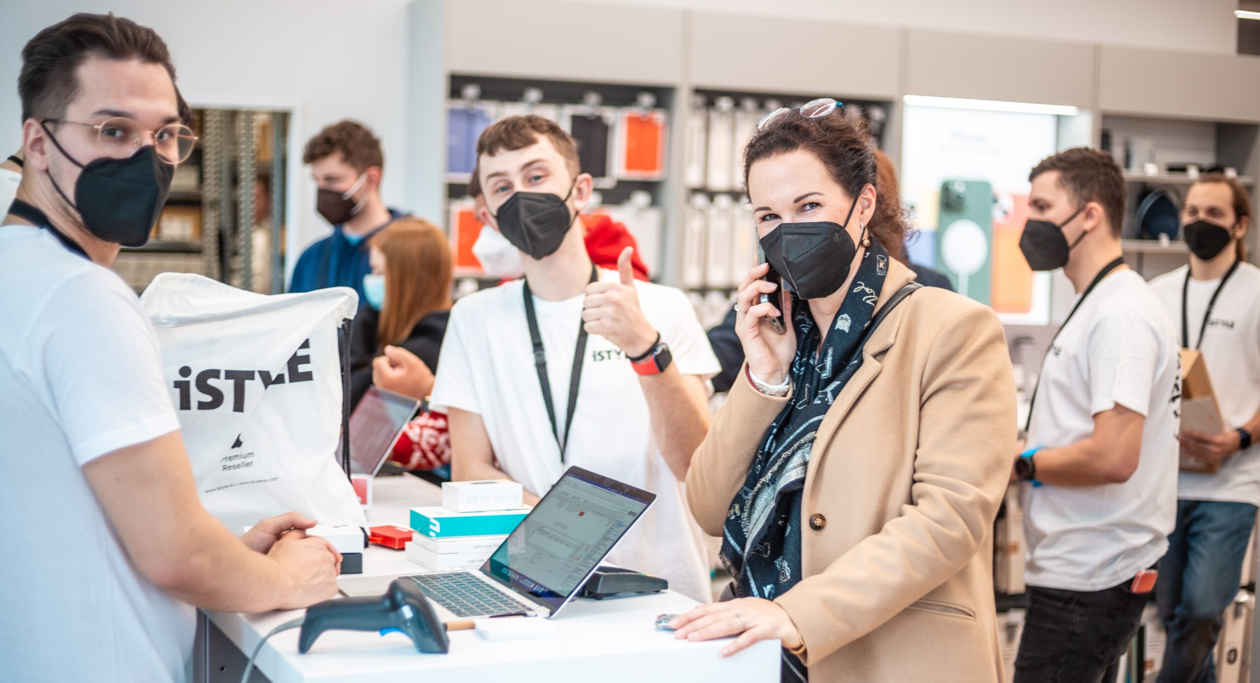 a group of people are seen in a hi tech store