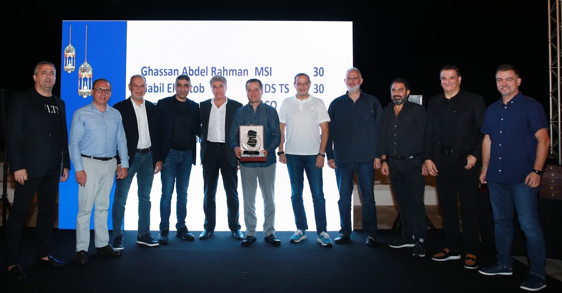 group of men stand shoulder to shoulder at an award presentation