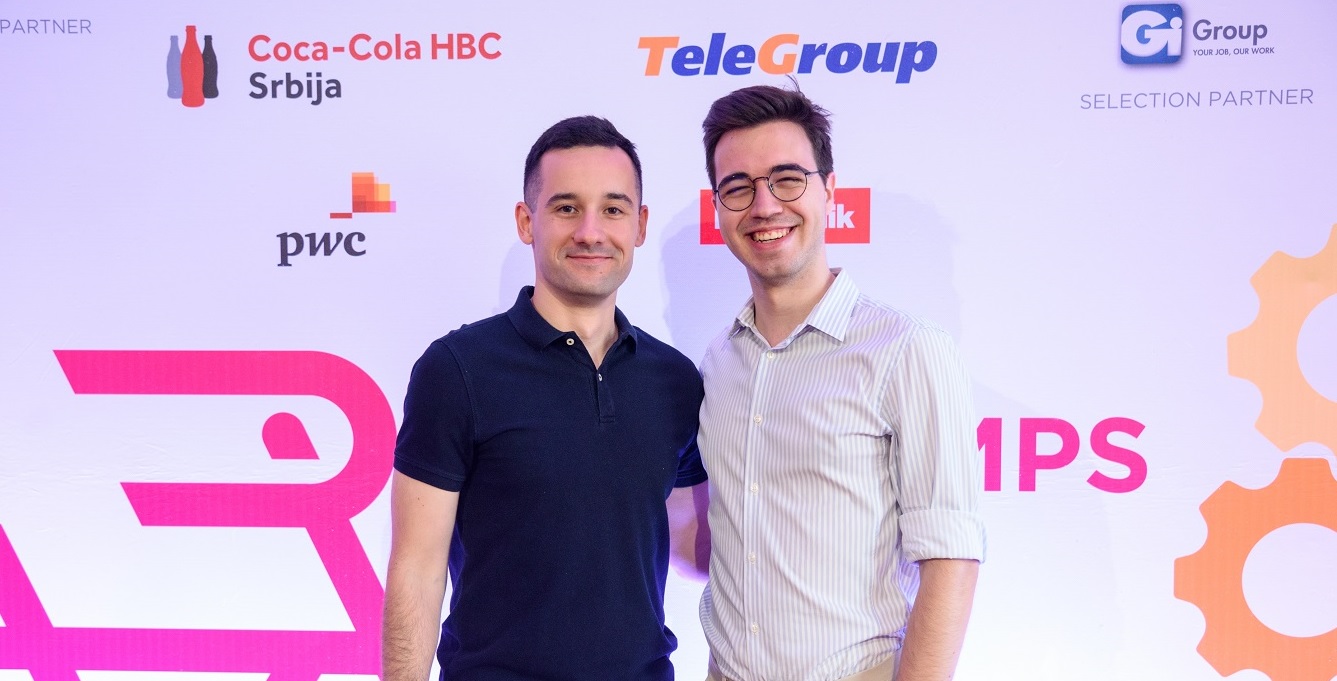 two men are side by side on a presentation stage