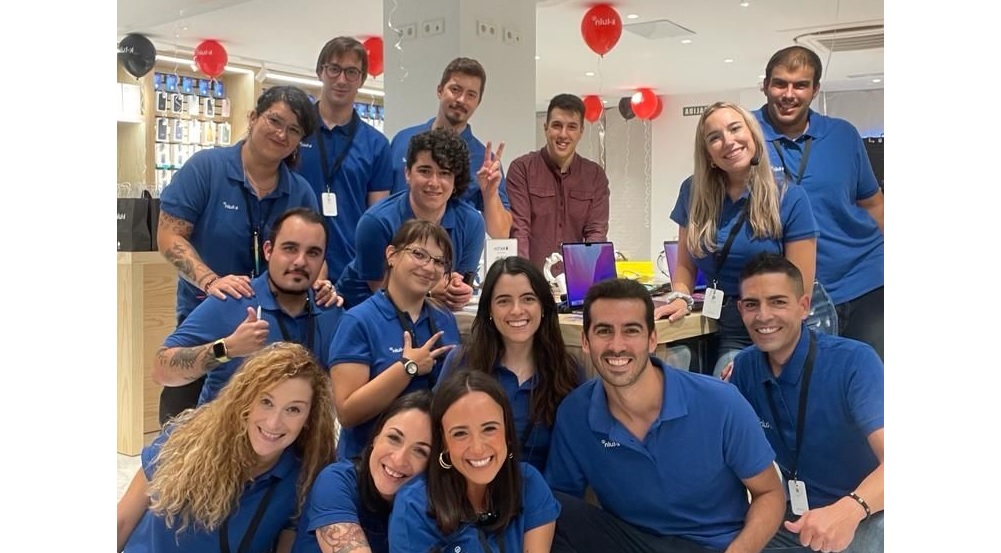 a large team of people crowd together in a group photo