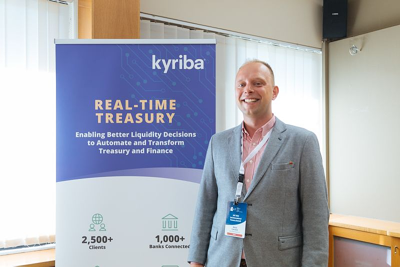 a man stands in front of a presentation banner