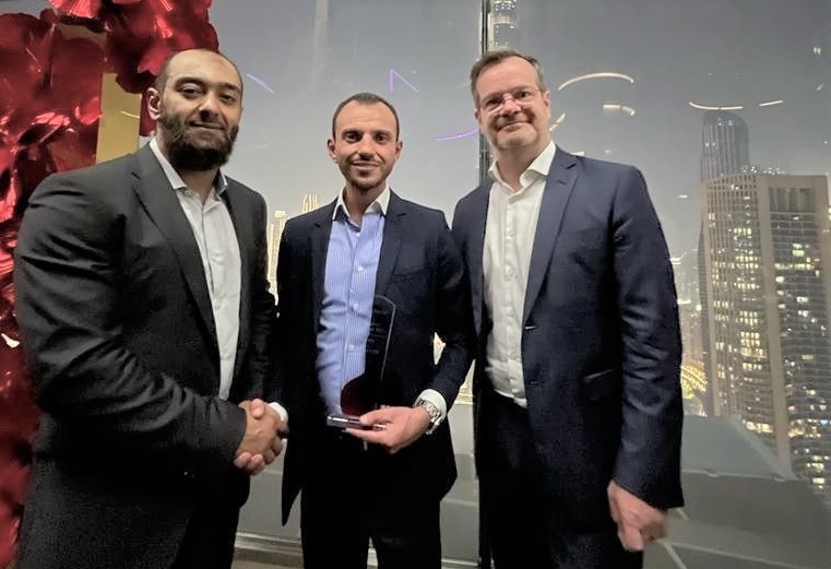 three men seen together shaking hands