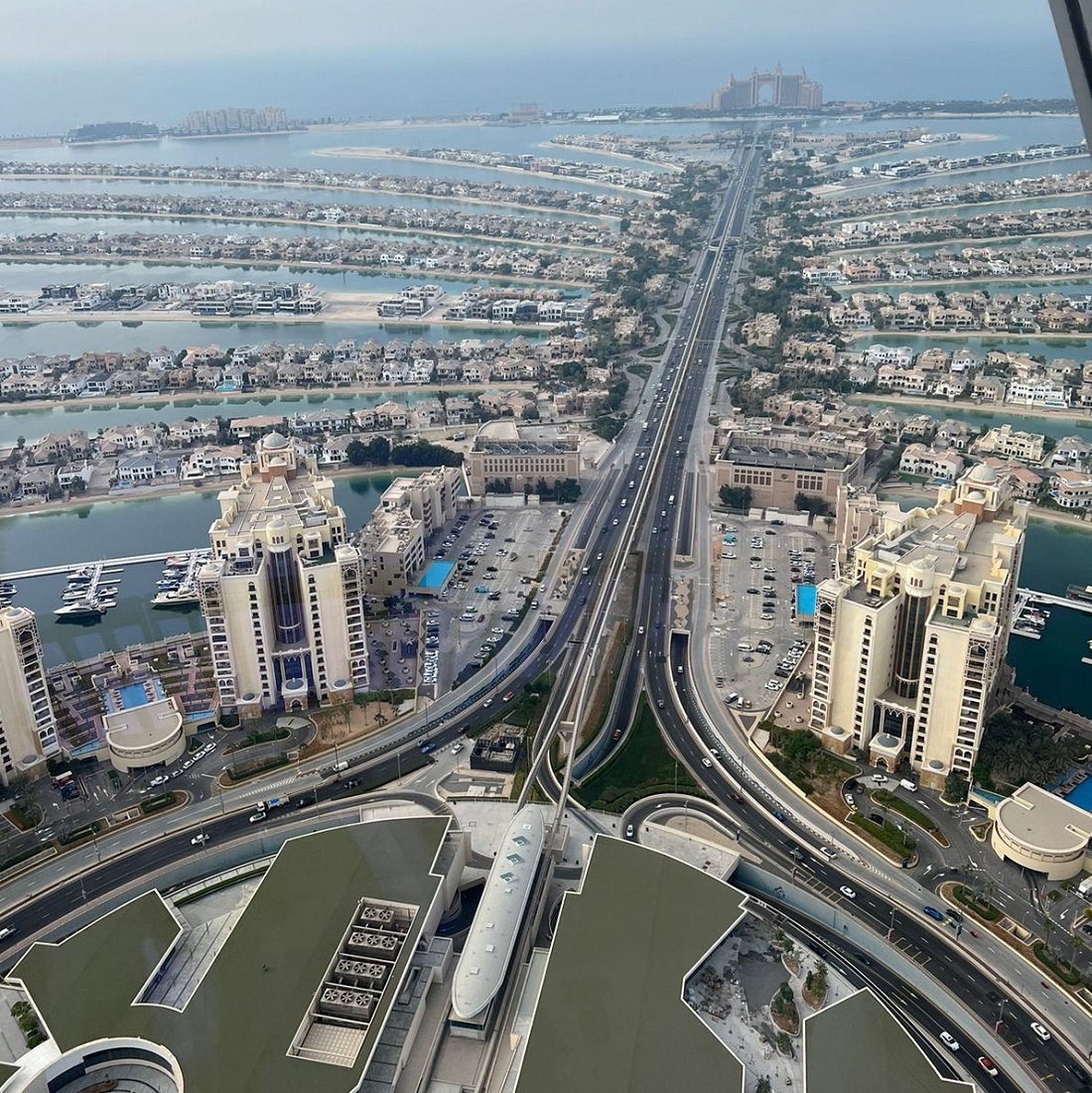 very high level view of a city with sea in the distance