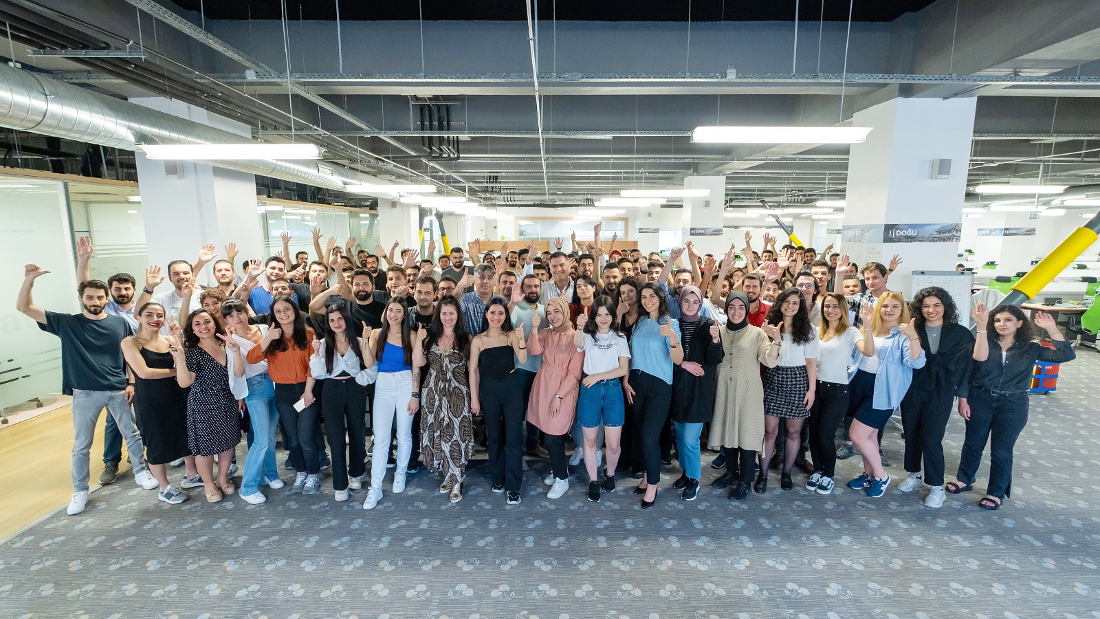 a very large group of people gathered for a group photo with many smiling