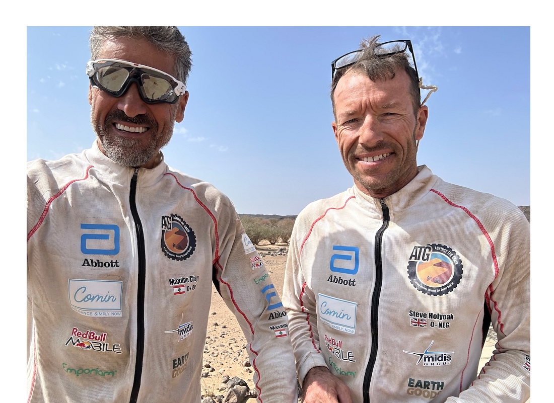 two men seen in a head and shoulders view - they are wearing sponsor logos on their clothes