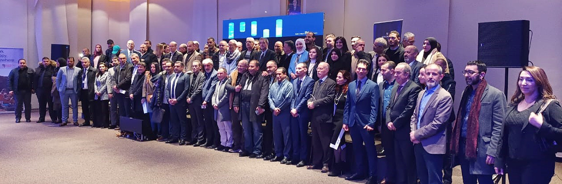 un très grand groupe de personnes se rassemble pour une photo de groupe