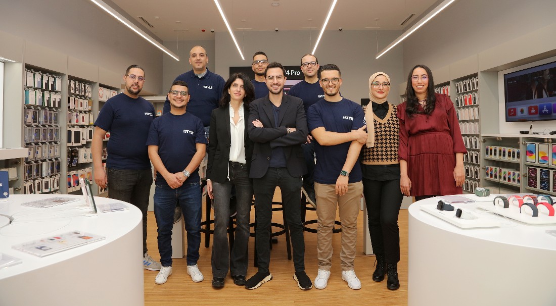 a group of people gathered for a photo together in a hi-tech retail site