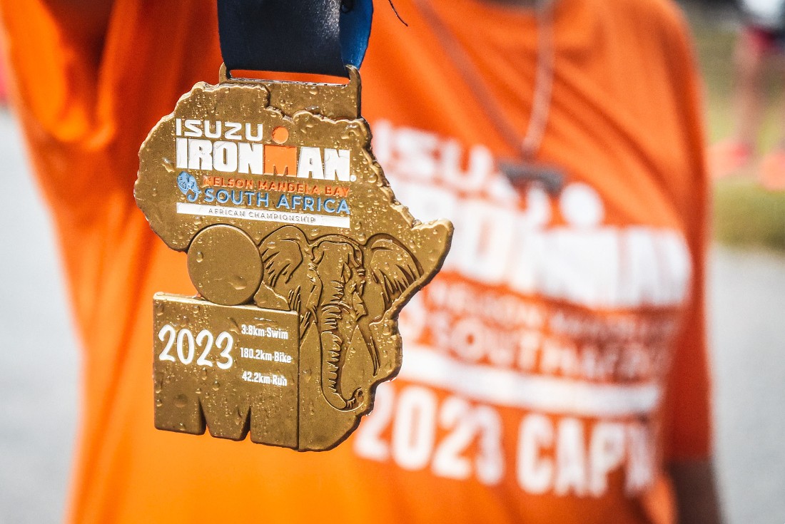 a gold colored medallion seen against an orange background