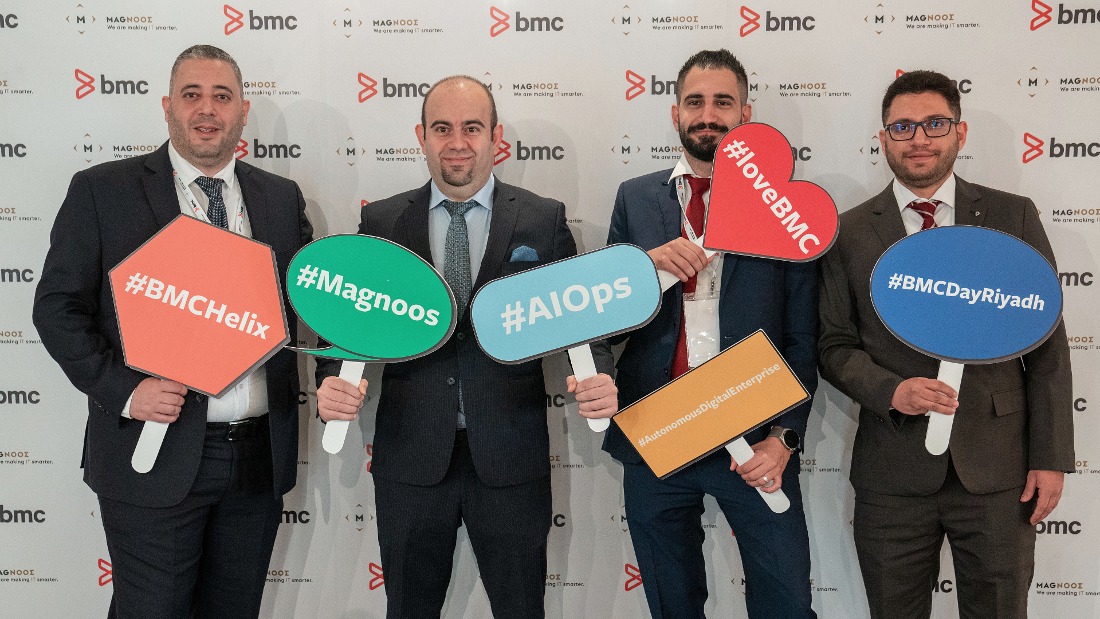 Four men holding colorful placards with words on them