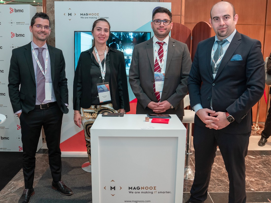 four people at an exhibition stand