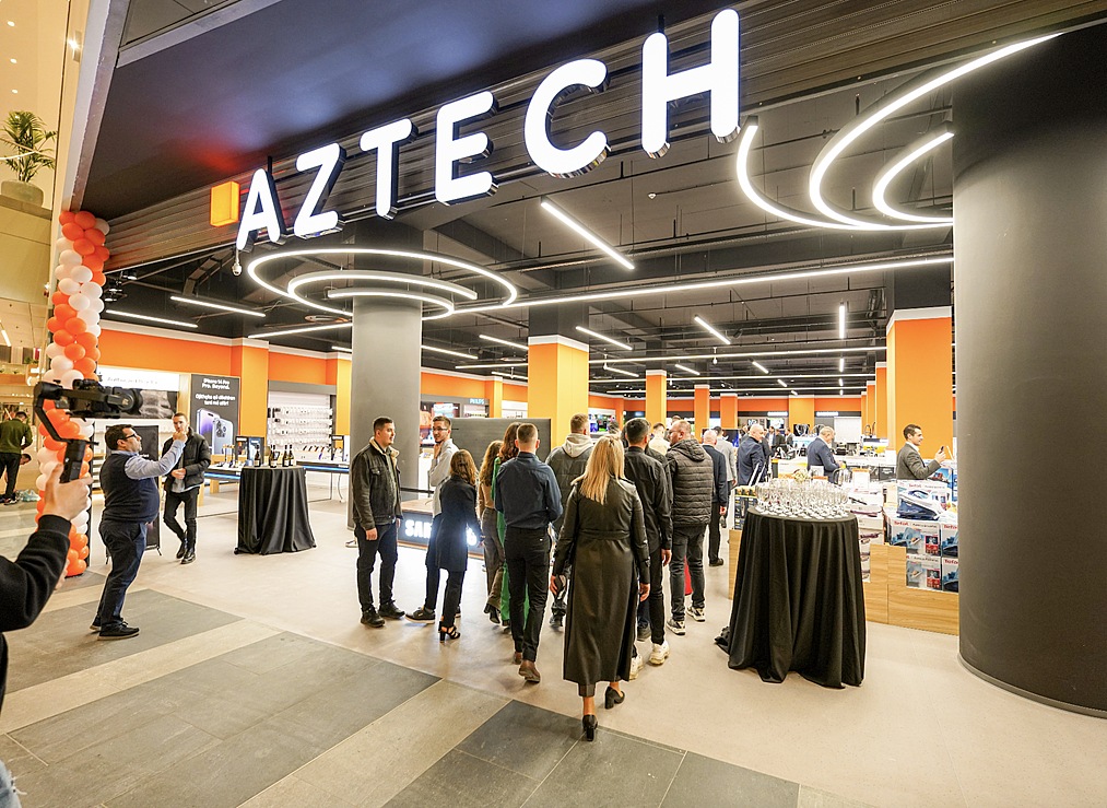 people gathering outside the front of a hi tech store
