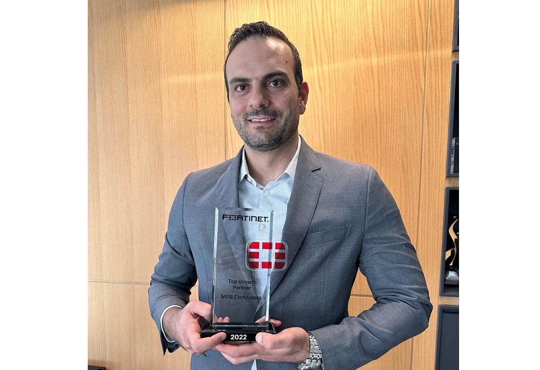 head and shoulders photo of a man holding a trophy