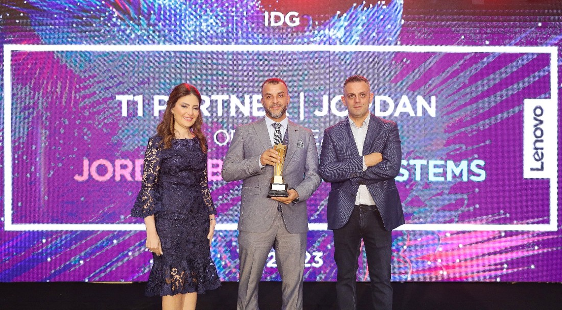 three people are seen at a presentation with the central person holding a trophy