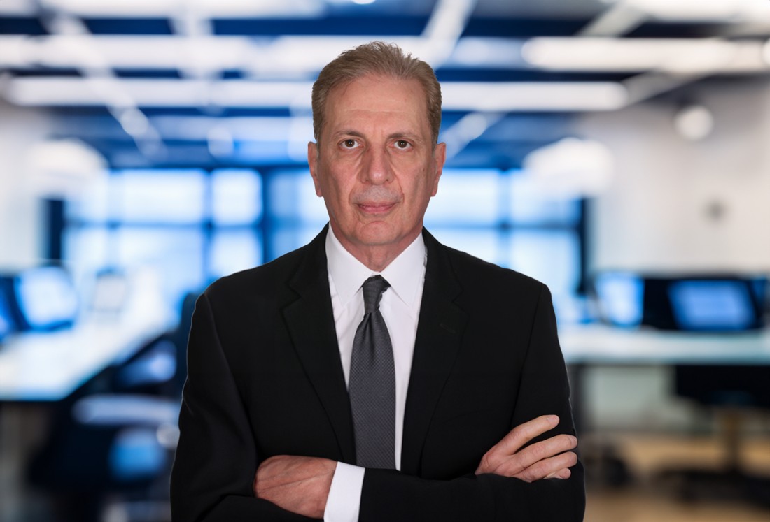 Head and shoulders view of a man in a suit in an office setting