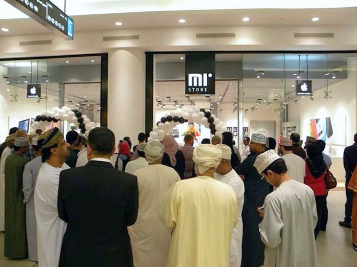 a gathering of people takes place outside a hi tech retail site