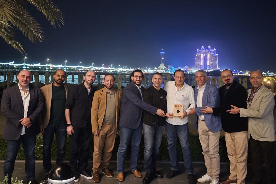 ten men are seen side by side with an award trophy