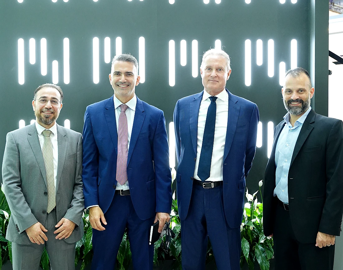 four men in suits seen in a group photograph
