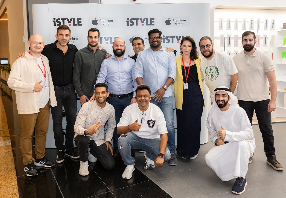 12 people are seen in a group photo at a retail site opening