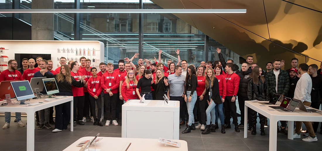 a large group of people, many with red t-shirts, are gathered in a group photo 