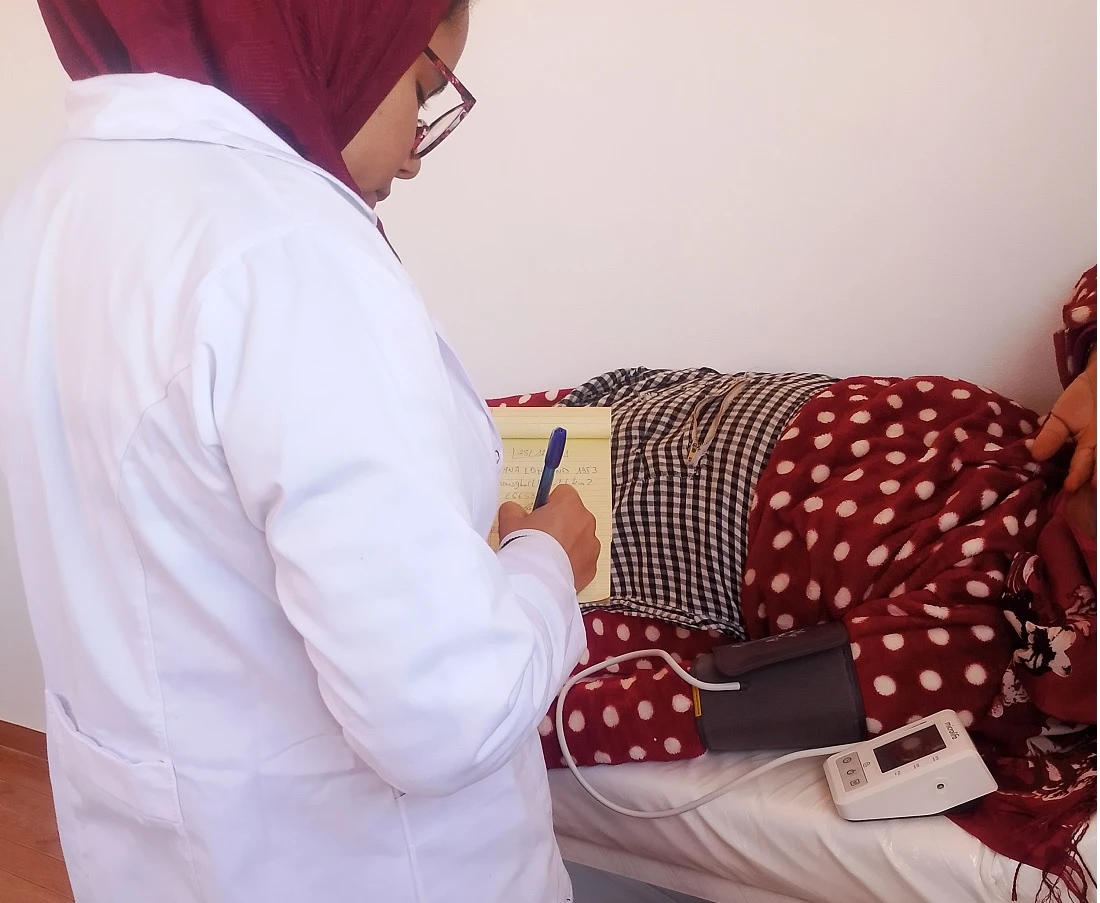 a medical officer takes a blood pressure reading