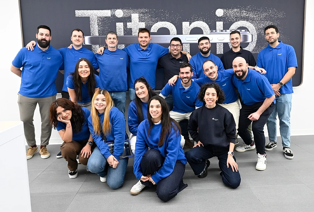 a team of people in blue t-shirts in a fun group photo