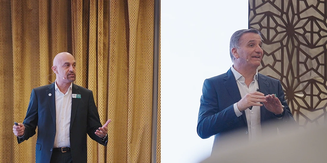 two men are seen on a presentation stage 