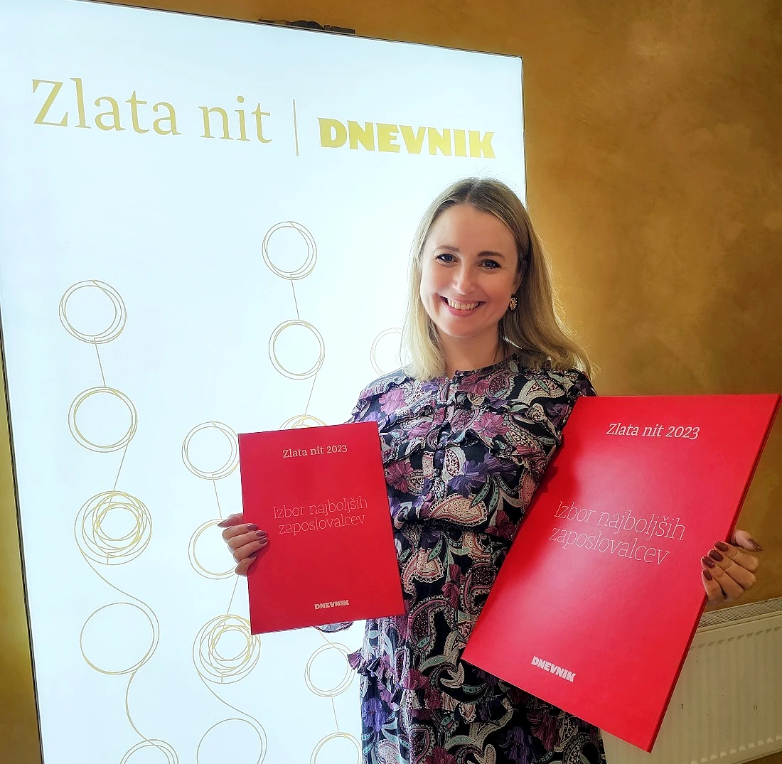 a woman holds two award portfolios