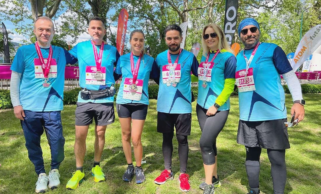 six people in colorful running gear are seen in a group photo