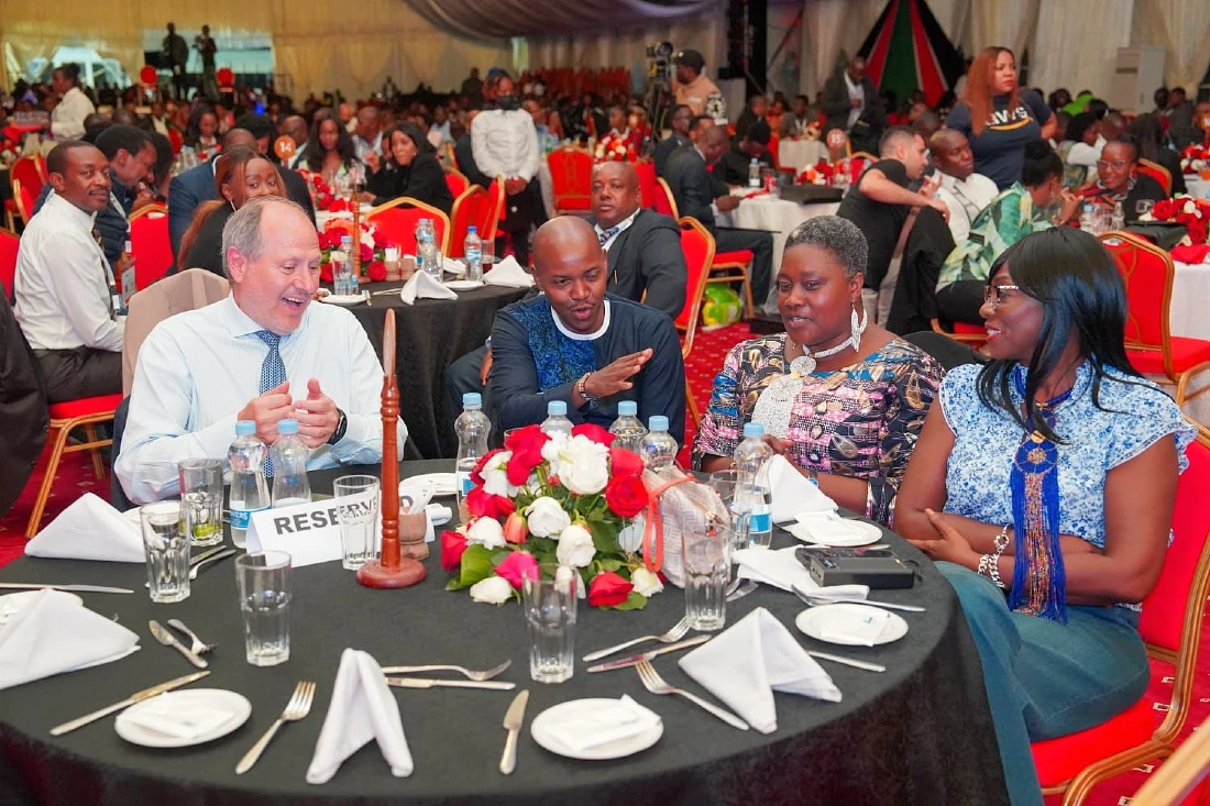 Four people are seen at a table at a grand reception