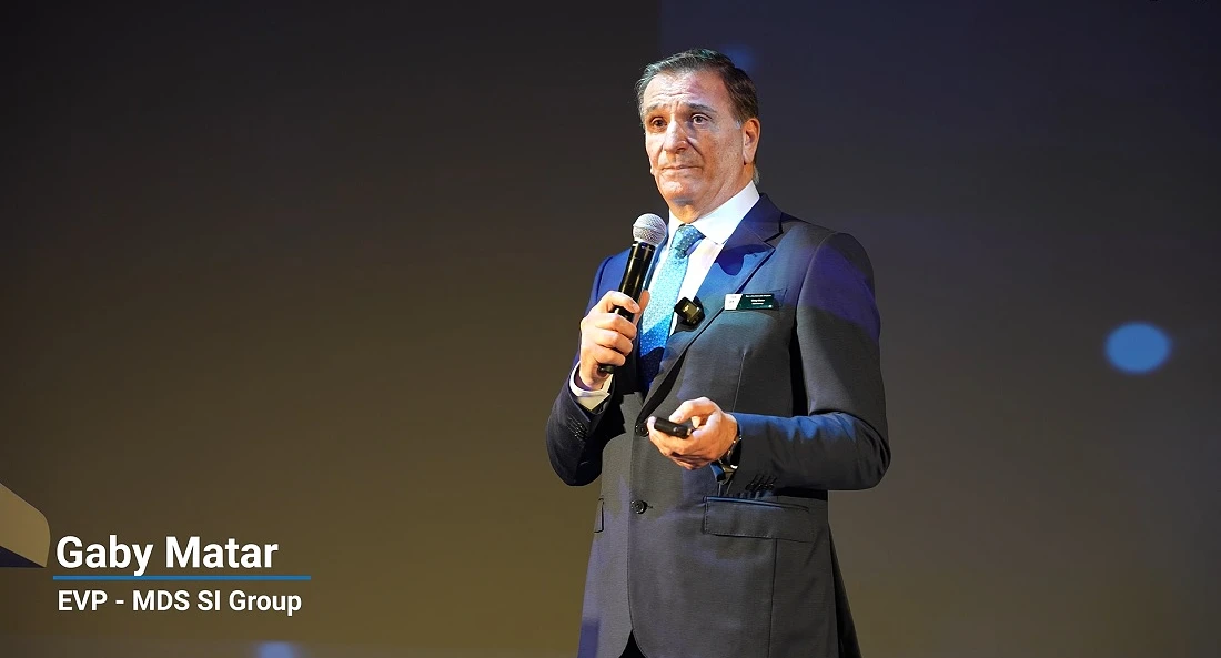 a man in a suit makes a presentation