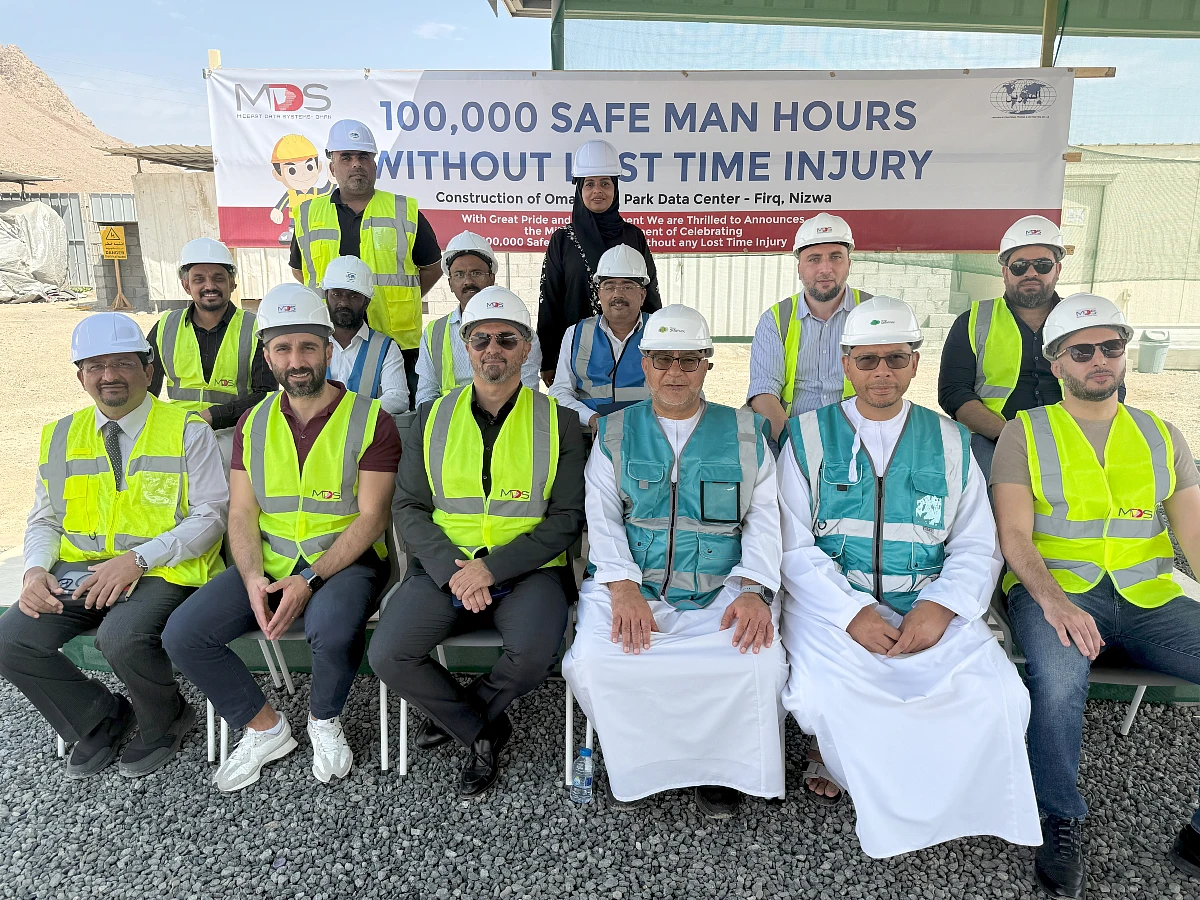 a group of men in a photograph wearing hi vis jackets and hard hats