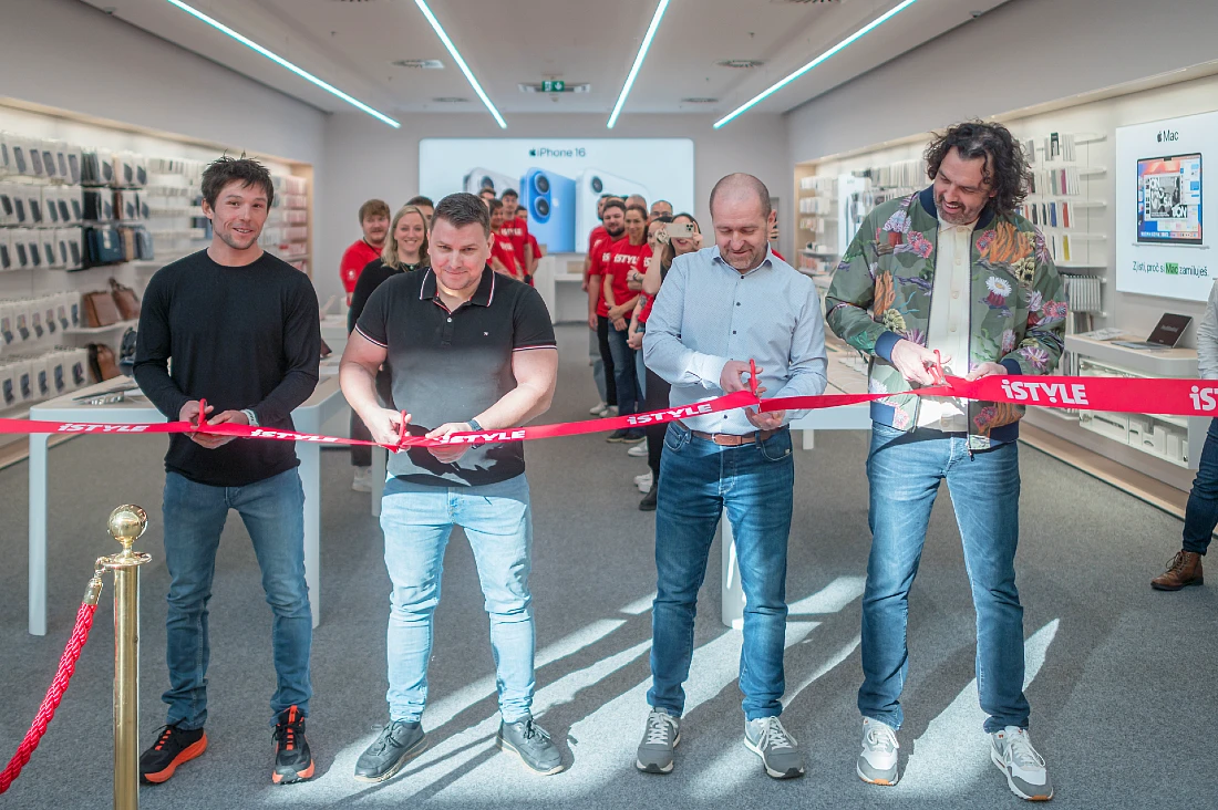 four men are seen as they cut a red tape to open a hi tech store