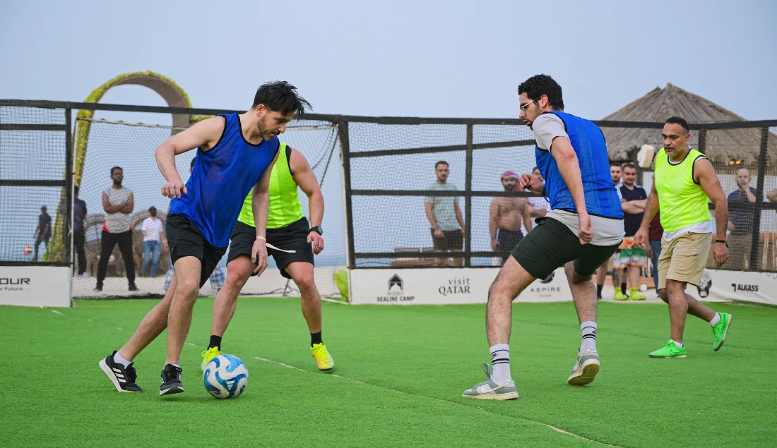 four people are seen playing a football match