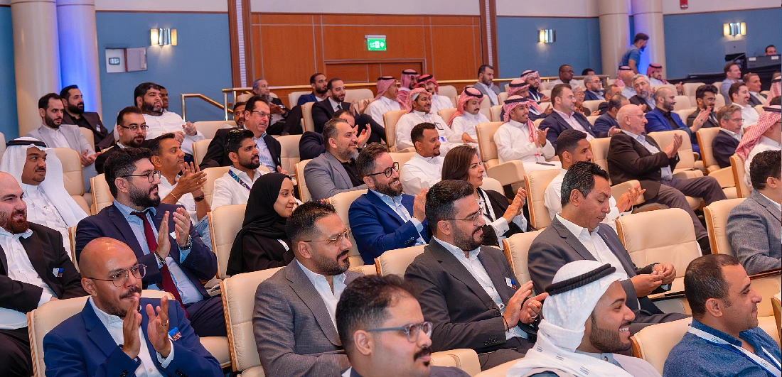 view of attendees applauding a speaker at an event