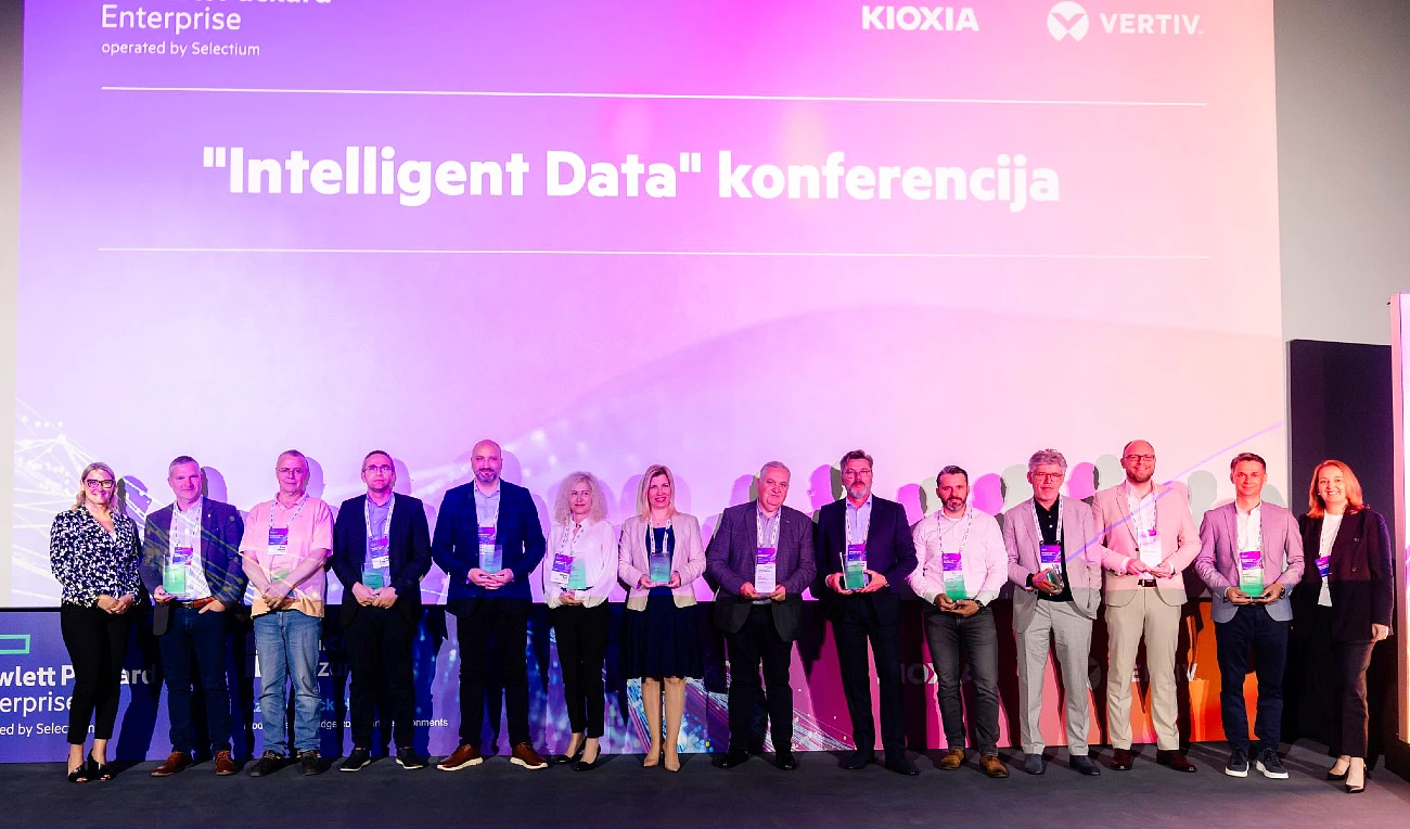 fourteen people in a group photograph with most of them holding trophies