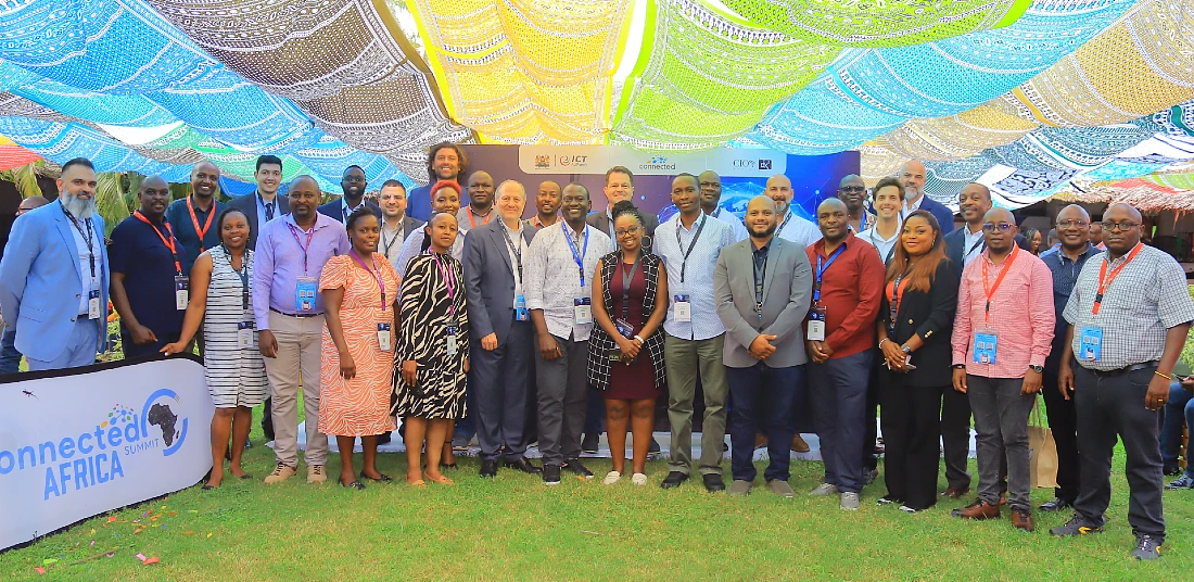 a group photograph taken under a multi coloured canopy